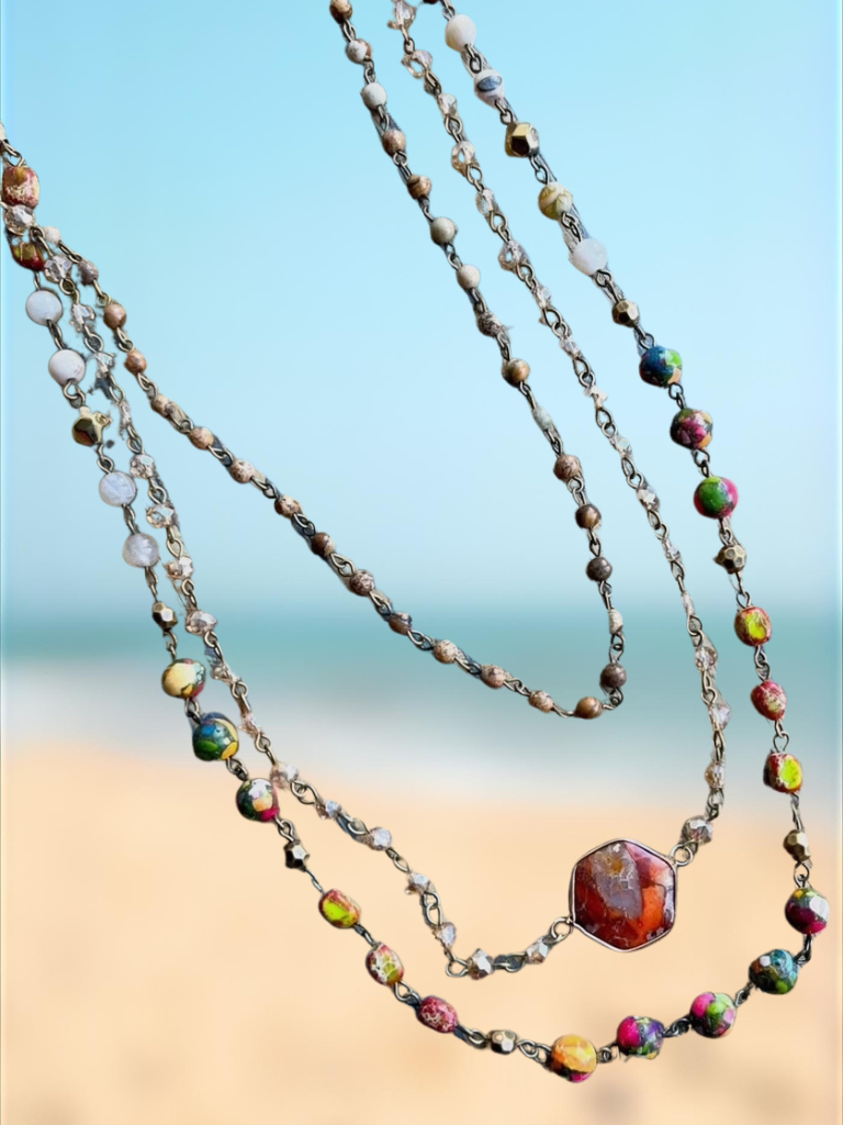 Earth & Embers Boho Gemstone Multi-chain Necklace Shown on Beach Background with 3 Layers.