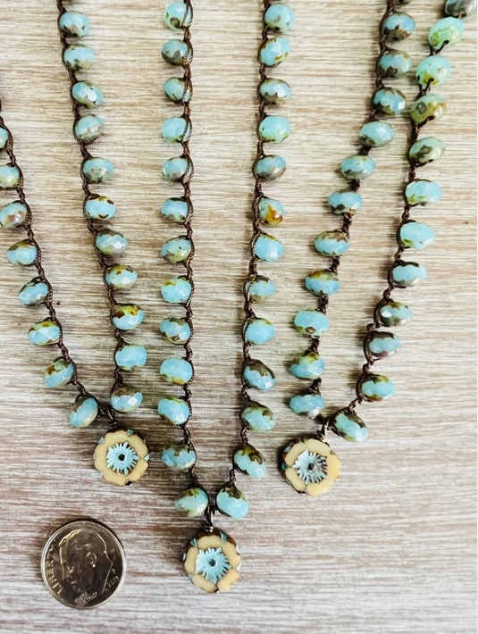 Sand and Sky Pressed Glass Flower Necklaces. Shows a Dime for Size Reference of Flower Detail