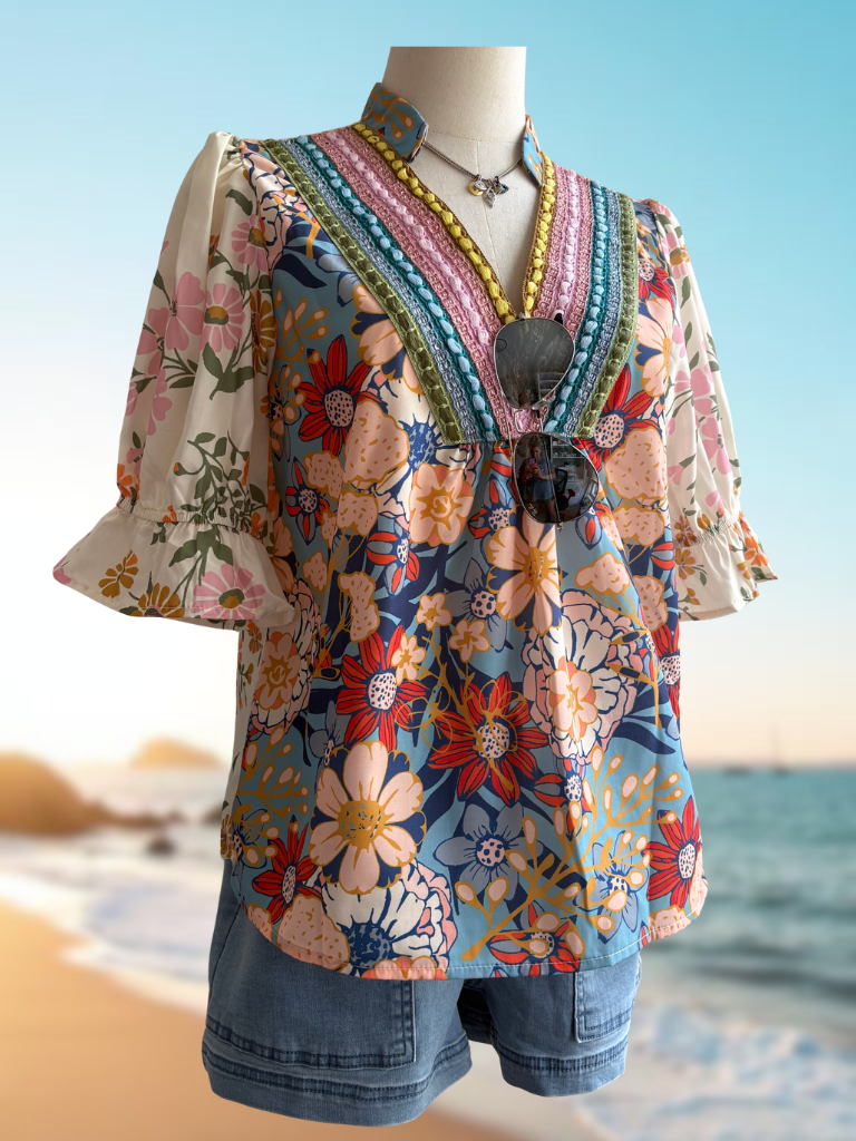 Sunset Bloom Crochet Trim Boho Blouse On form Front View. Wearing Weekend Wanderer Boat Shorts and Eyes of Protection Necklace