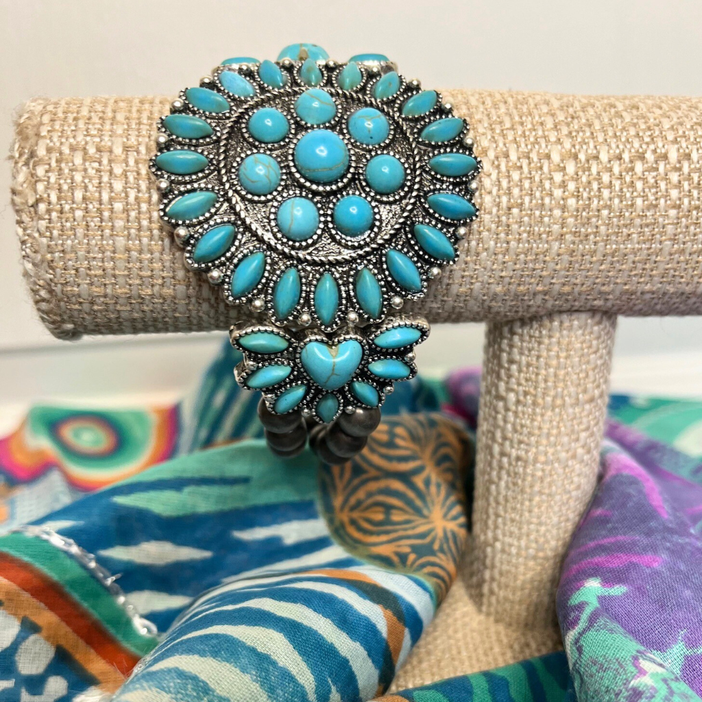 Western Boho Style Stretch Bracelet - Turquoise Stones with Burnished Silver Beads. On Bracelet Display Sitting on top of Sarong.