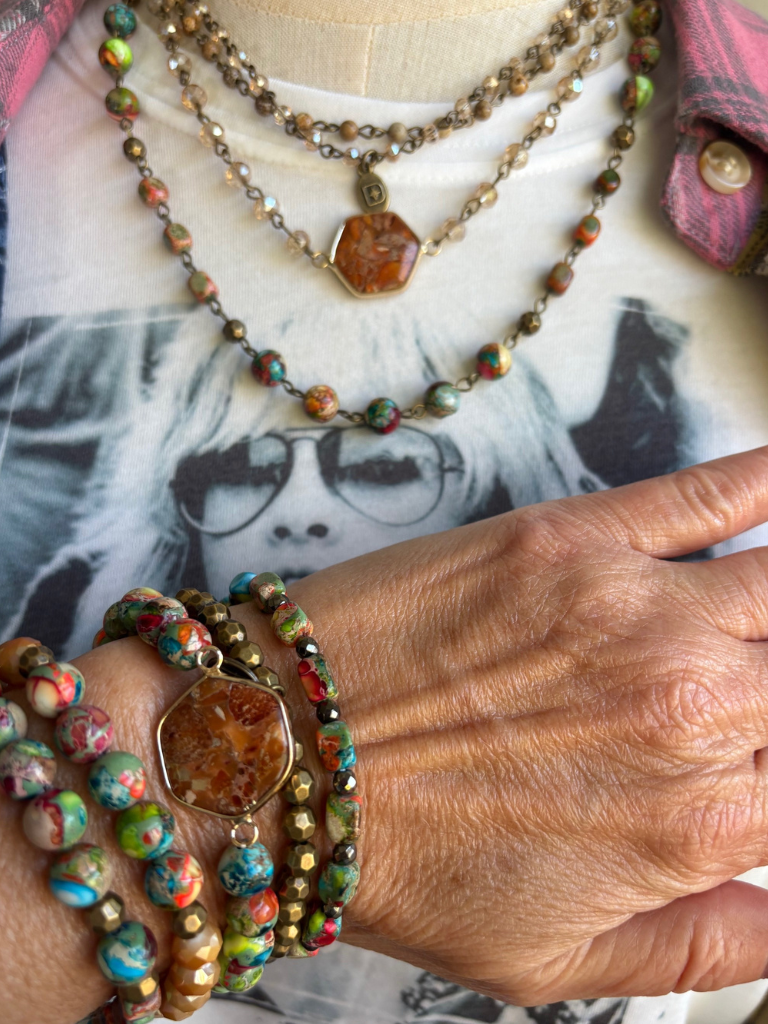 Earth & Embers Boho Gemstone Multi-chain Necklace Shown Close Up and Short, with  4 layers, on Model with Gypsy Soul Tee and the Free Spirit Plaid Flannel shirt.