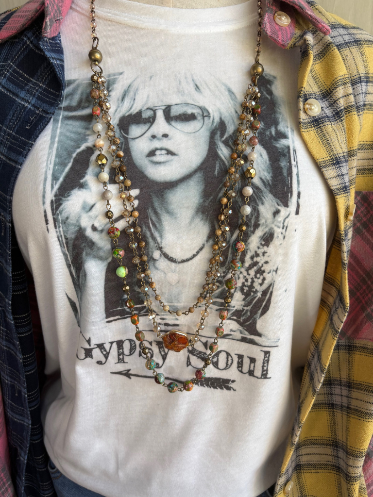 Earth & Embers Boho Gemstone Multi-chain Necklace Shown Long on Model with Gypsy Soul Tee and the Free Spirit Plaid Flannel shirt.