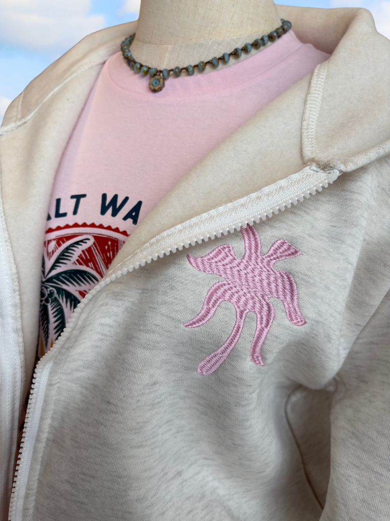 Coastal Bloom Hibiscus Embroidered Zip-Up Ladies Hoodie Front on Form, Close Up View, Shows Embroidered Palm Tree on Upper Left Chest, Salty Water Graphic Tee and Necklace