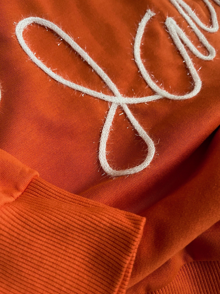 Orange Game Day Sweatshirt Close Up View of White Tinsel Yarn Detail