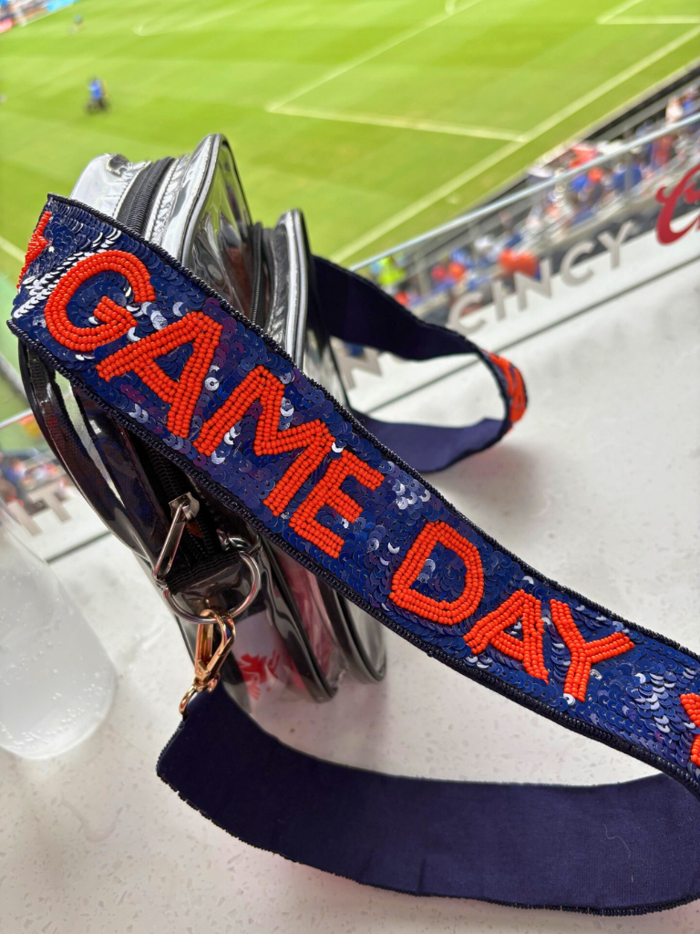 Game Day Spirit Blue Sequin Removable Purse Strap with Orange "GAME DAY" Seed Bead and Stars, on a Clear Stadium Bag at a game
