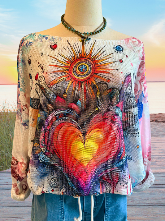 Hearts Aglow - Ladies Loose Knit, Round Neck, Boho Sweater Front View Close Up. Bold, heart-and-sun inspired design with colorful accents