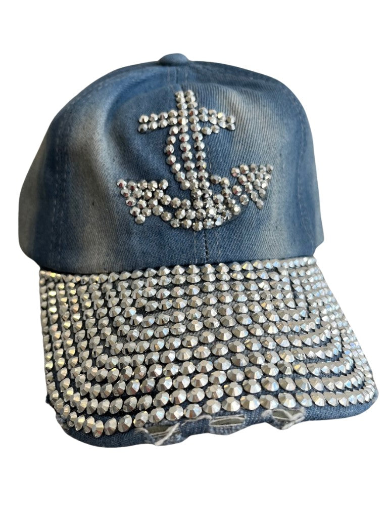 Denim cap with rhinestone anchor design on a white background