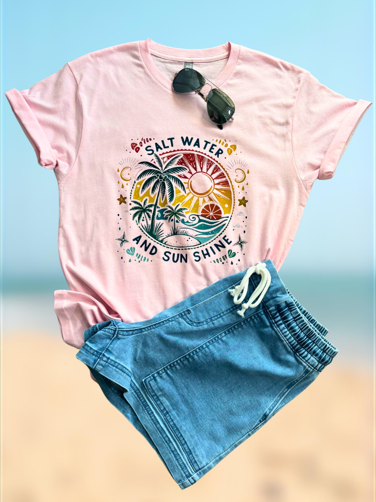 Salt Water and Sunshine Tee with tropical design and Weekend Wanderer Denim Boat shorts on a beach background