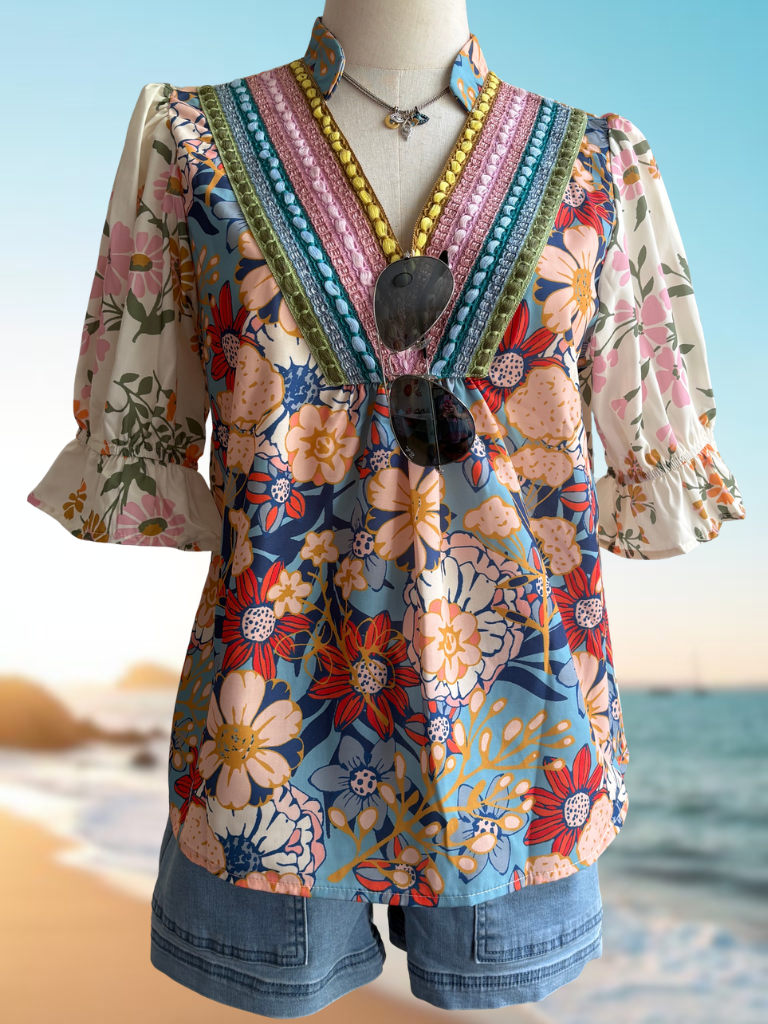 Sunset Bloom Crochet Trim Boho Blouse On form Front View. Wearing Weekend Wanderer Boat Shorts and Eyes of Protection Necklace